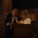 Gary reads the plaque